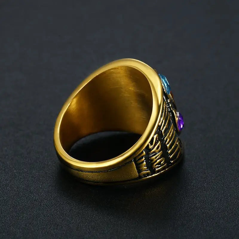 Gold ring with gemstones on a dark background