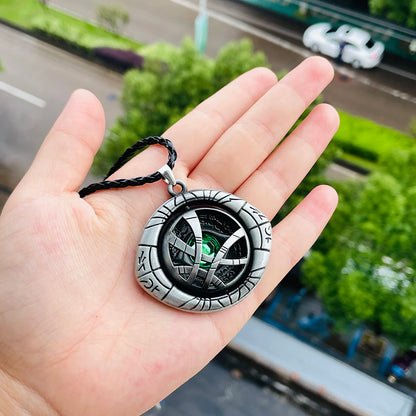 a gold Doctor Strange Eye of Agamotto Necklace featuring engraved detailing and a green centerpiece gem, inspired by the Marvel Doctor Strange movies.