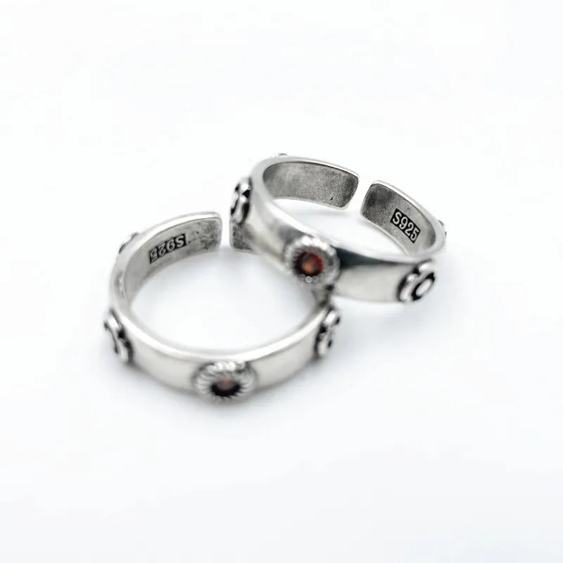 Two silver rings with embedded stones on a white background