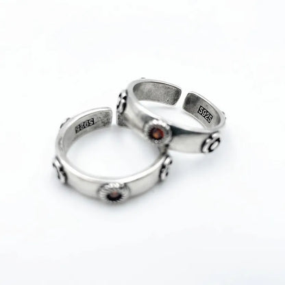 Two silver rings with embedded stones on a white background