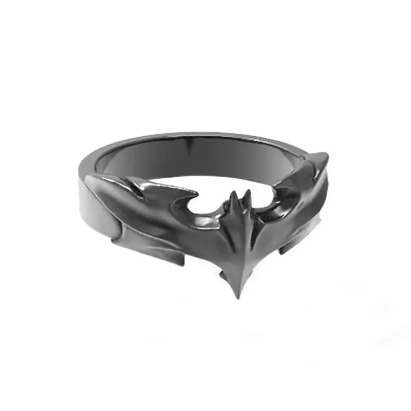 Metallic bat-shaped ring on a white background