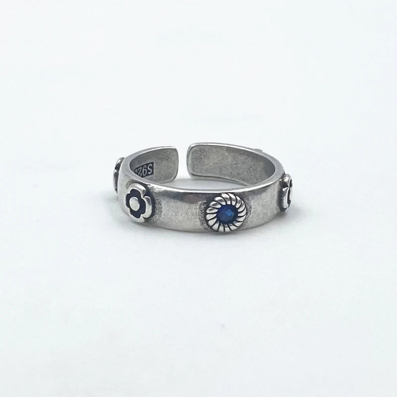 Silver ring with blue stone on a white background