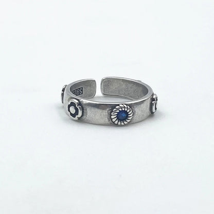 Silver ring with blue stone on a white background