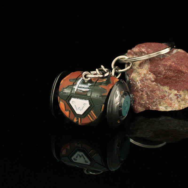 Keychain with a design resembling a robot or vehicle on a dark background