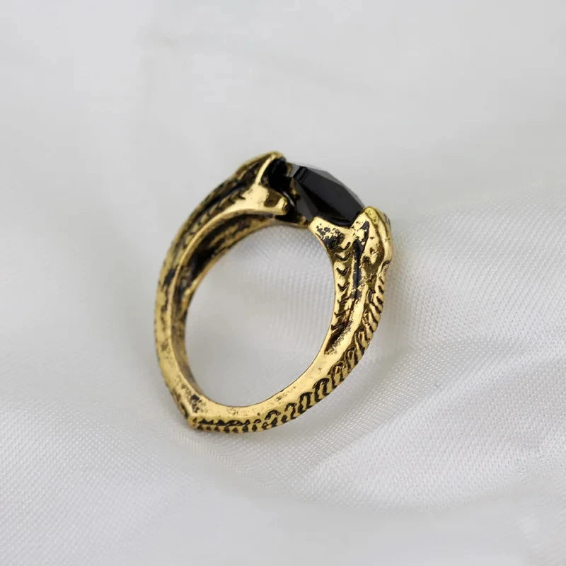 Profile shot of Voldemort’s Horcrux ring emphasizing the serpent-scale texture of the gold band and the black stone facet.