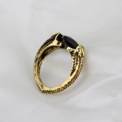 Profile shot of Voldemort’s Horcrux ring emphasizing the serpent-scale texture of the gold band and the black stone facet.