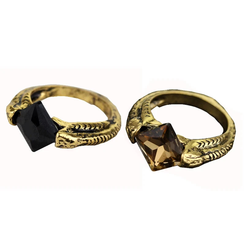Side-by-side comparison of Harry Potter Horcrux rings with black onyx and transparent brown stone options on a white background.