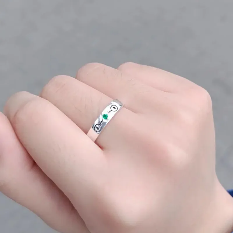 jujutsu kaisen silver ring with green emeral presented on a hand model