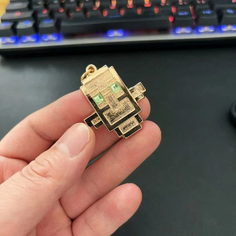 small golden totem of undying golden keychain held in a hand