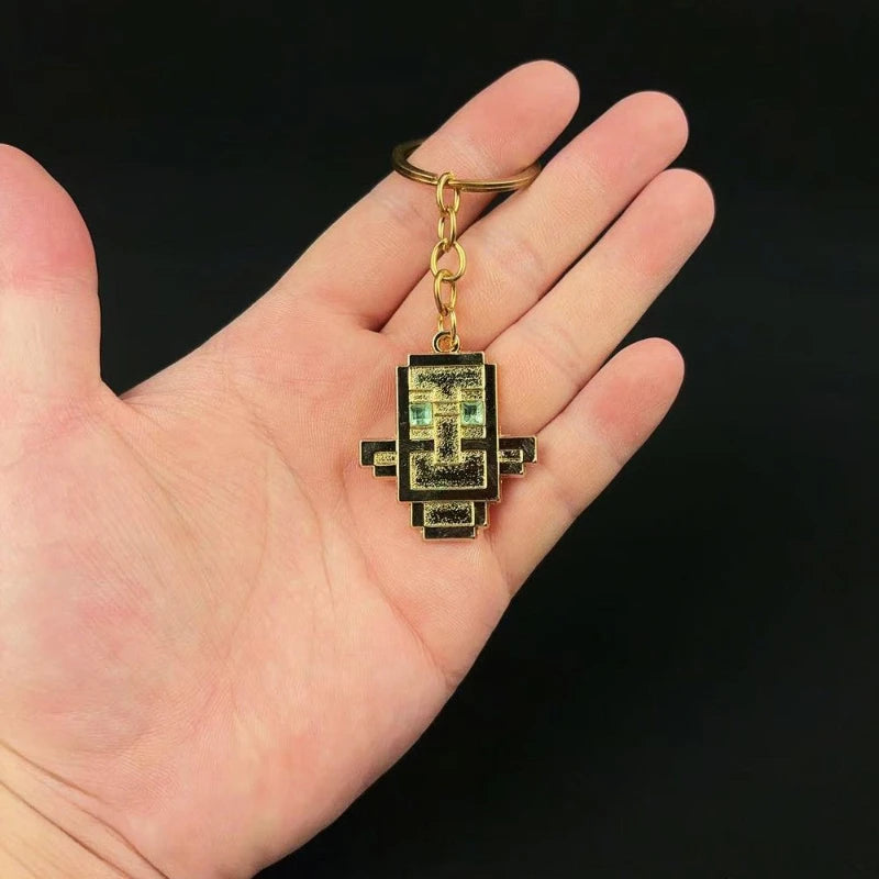small golden replica keychain of totem of undying