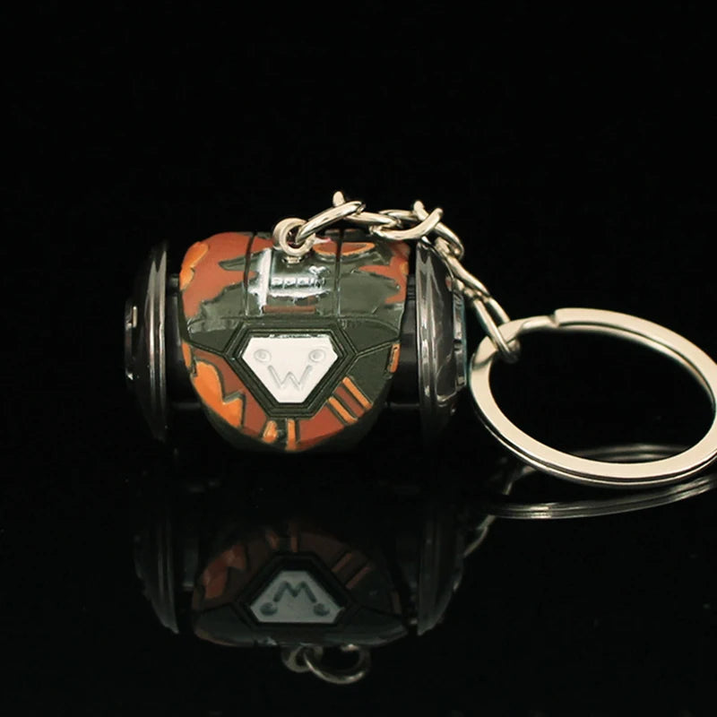 Keychain with a cylindrical design featuring orange, black, and silver colors on a black background.