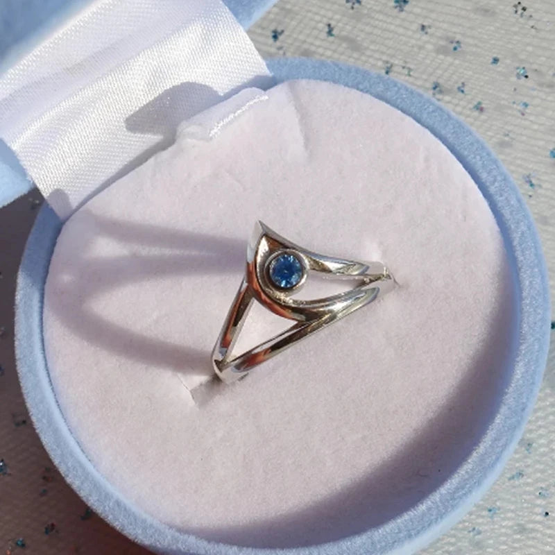 Silver ring with a blue gemstone on a white cushion from the video game Valorant